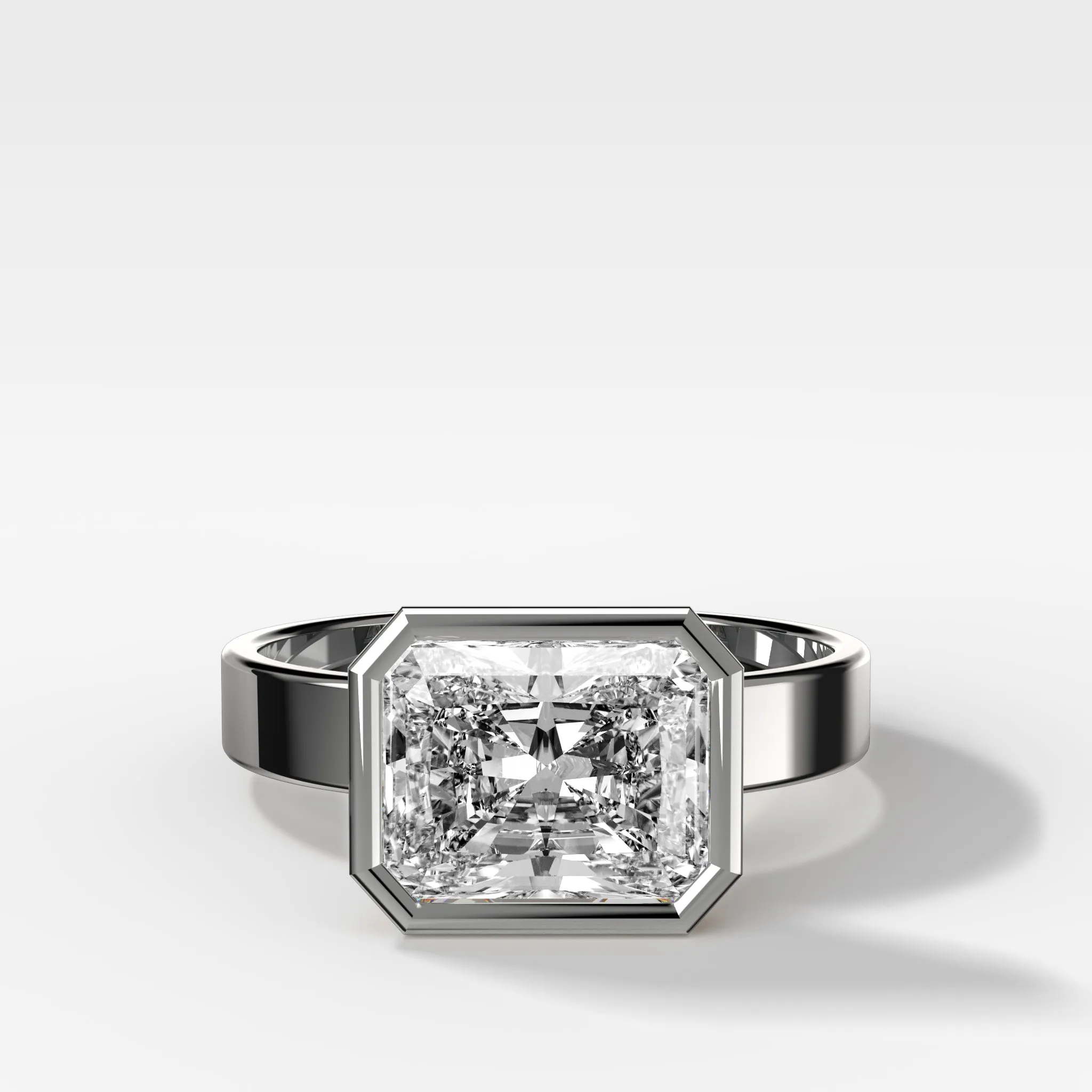 Finest Bezel Set Engagement Ring With East West Elongated Radiant Cut Diamond