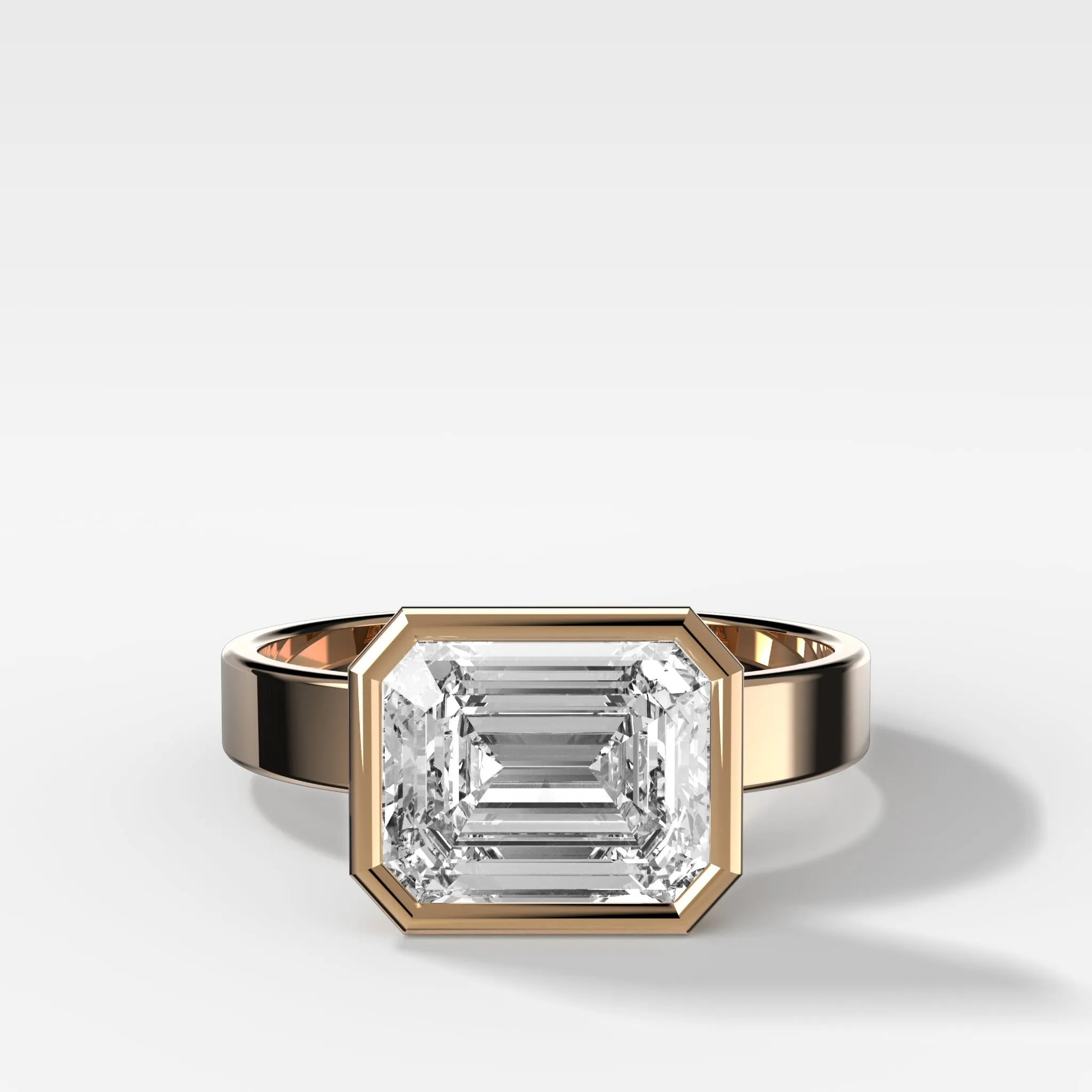 Finest Bezel Set Engagement Ring With East West Emerald Cut Diamond