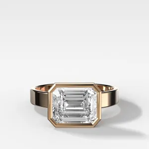 Finest Bezel Set Engagement Ring With East West Emerald Cut Diamond