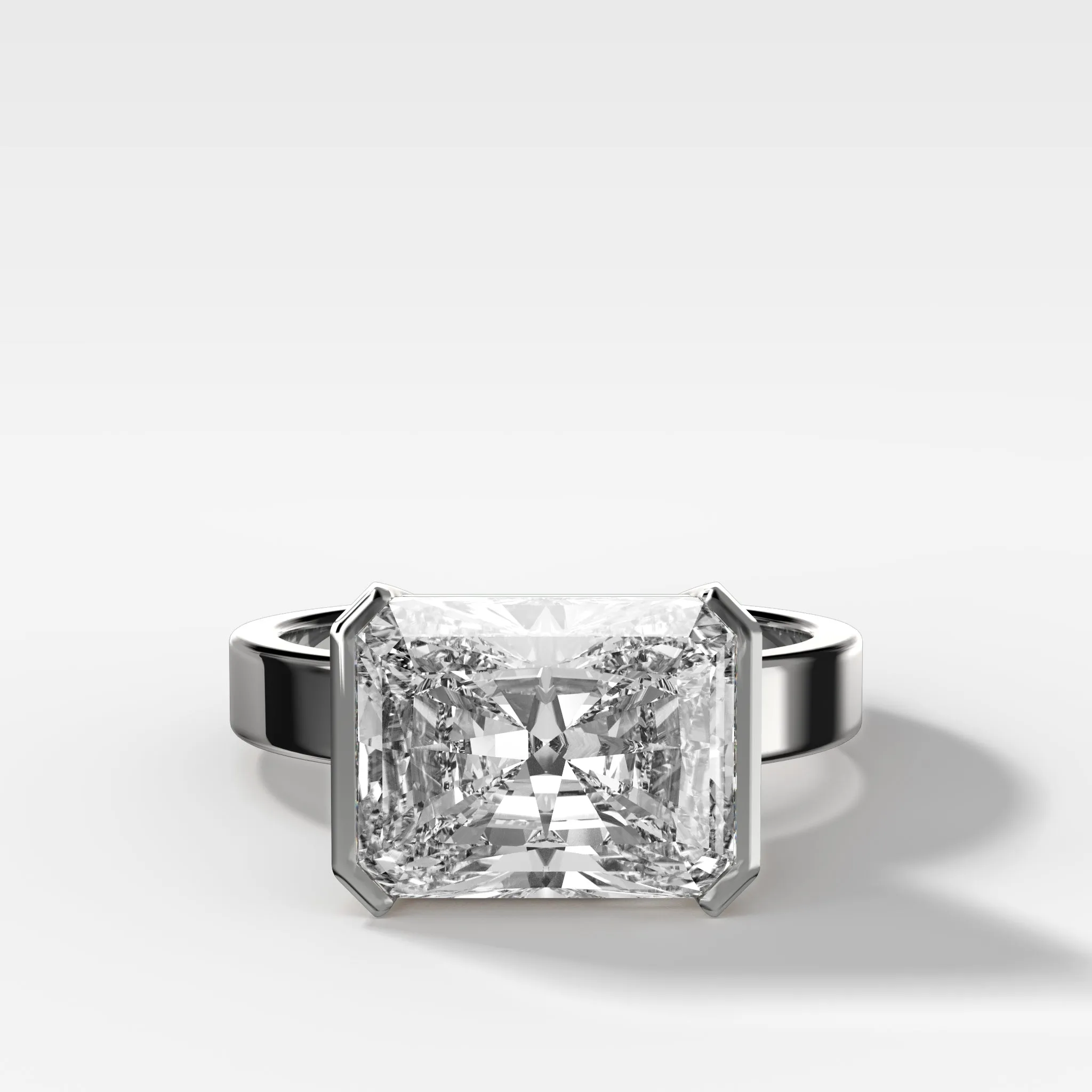 Finest Half Bezel Solitaire Engagement Ring With East West Elongated Radiant Cut Diamond