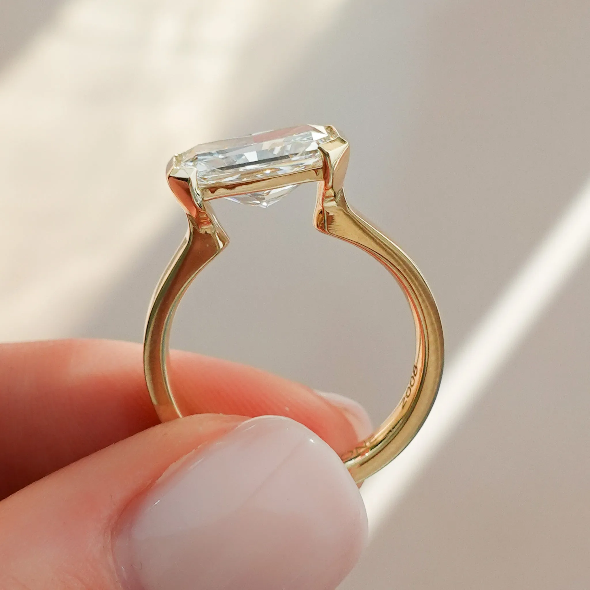 Finest Half Bezel Solitaire Engagement Ring With East West Elongated Radiant Cut Diamond