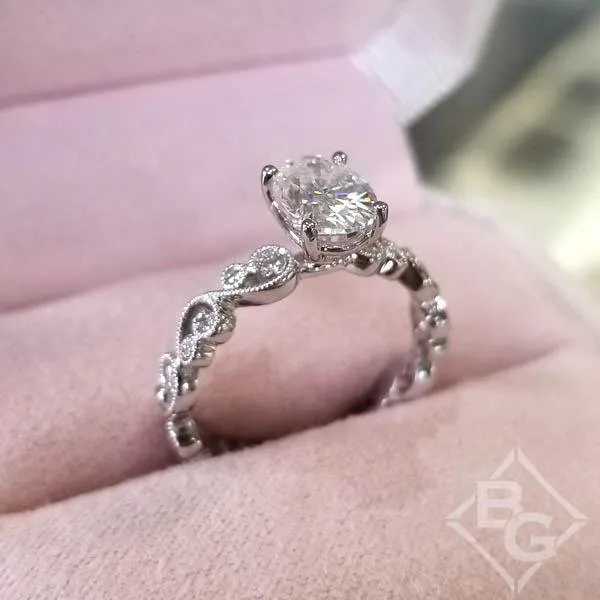 Kirk Kara "Angelique" Oval Cut Moissanite Center Scroll Work Engagement Ring