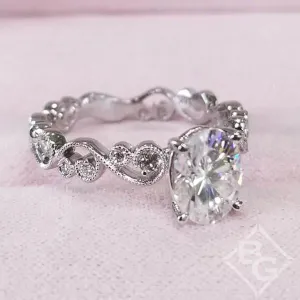Kirk Kara "Angelique" Oval Cut Moissanite Center Scroll Work Engagement Ring
