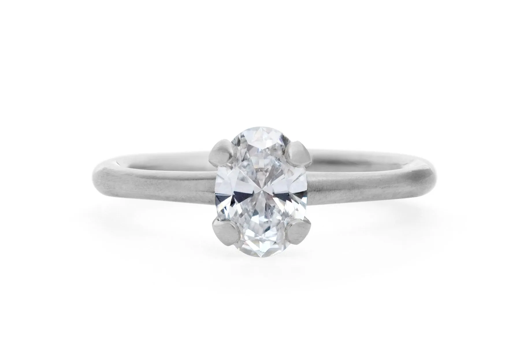 Oval diamond and platinum sculpted 4 claw engagement ring