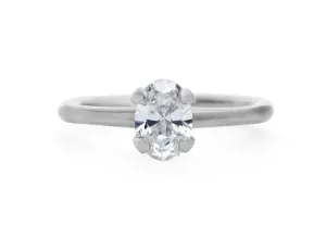 Oval diamond and platinum sculpted 4 claw engagement ring