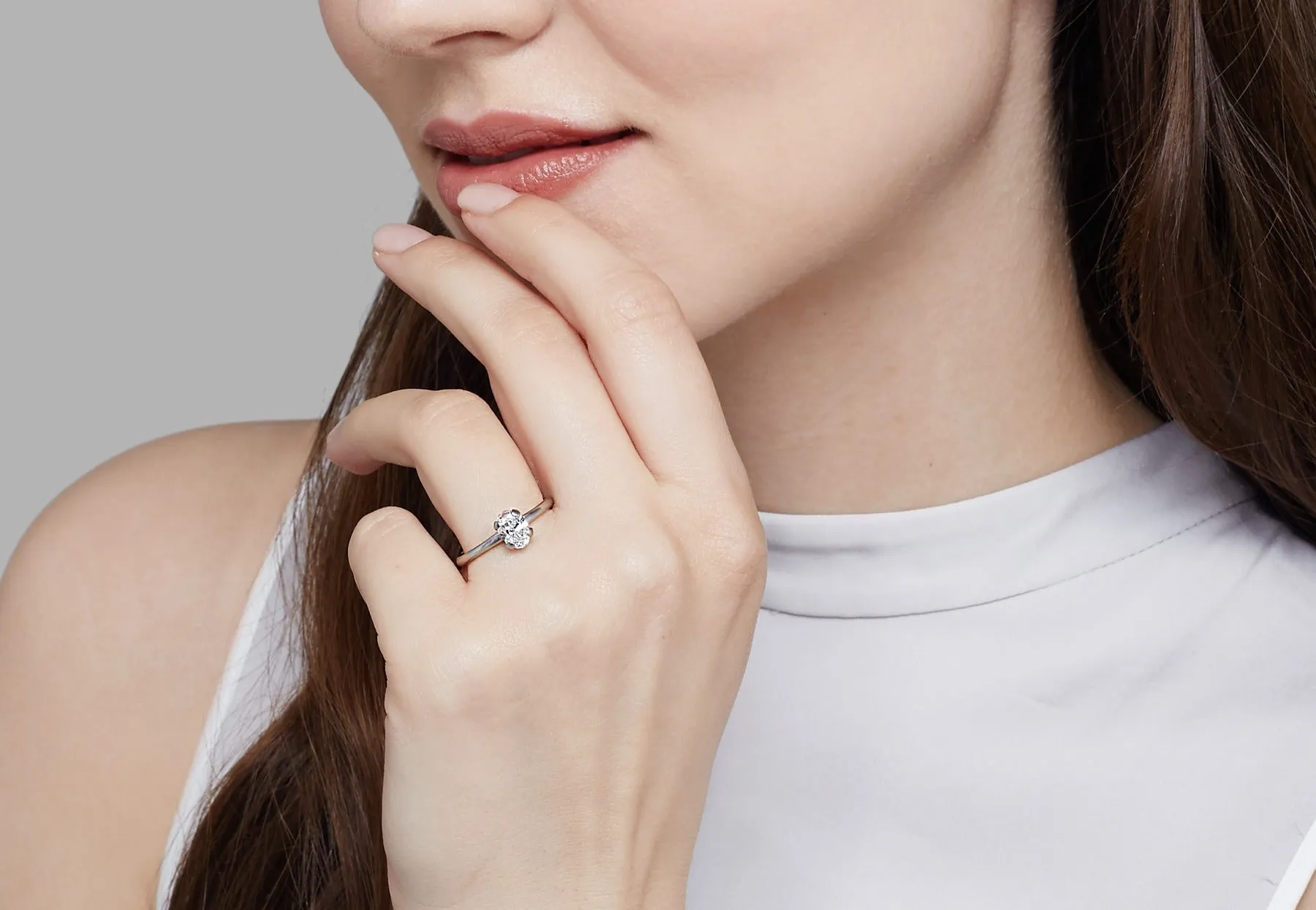 Oval diamond and platinum sculpted 4 claw engagement ring