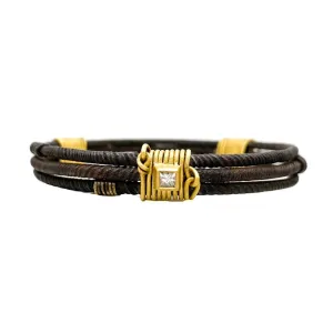 Three old African wrought iron "money" bracelets lashed together with 22K gold wires and set with diamonds